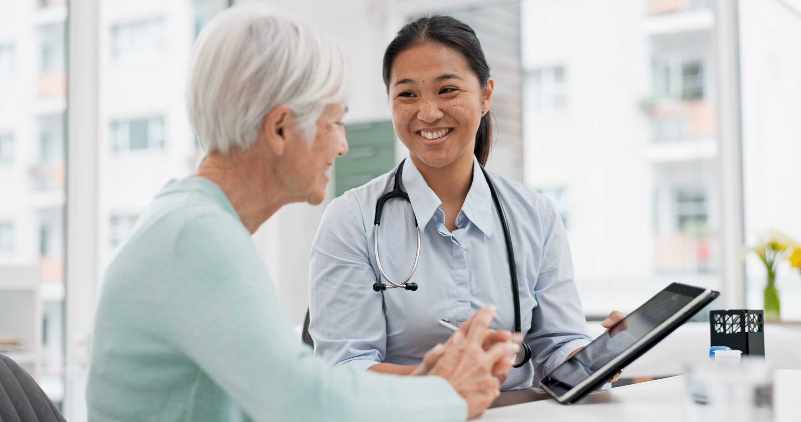 Health professional speaking with an older patient